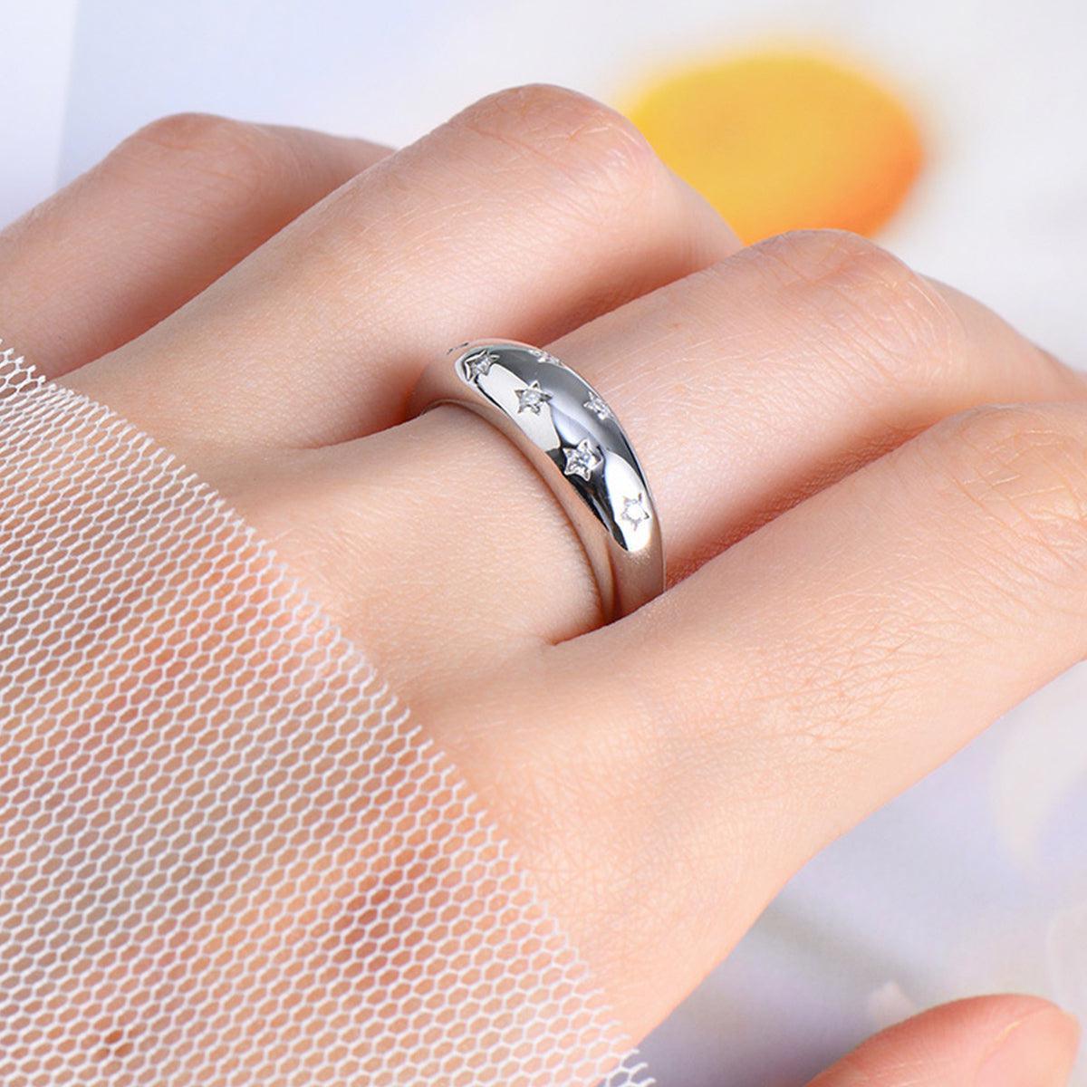 a woman's hand with a wedding ring on it