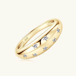 a yellow gold wedding ring with three diamonds