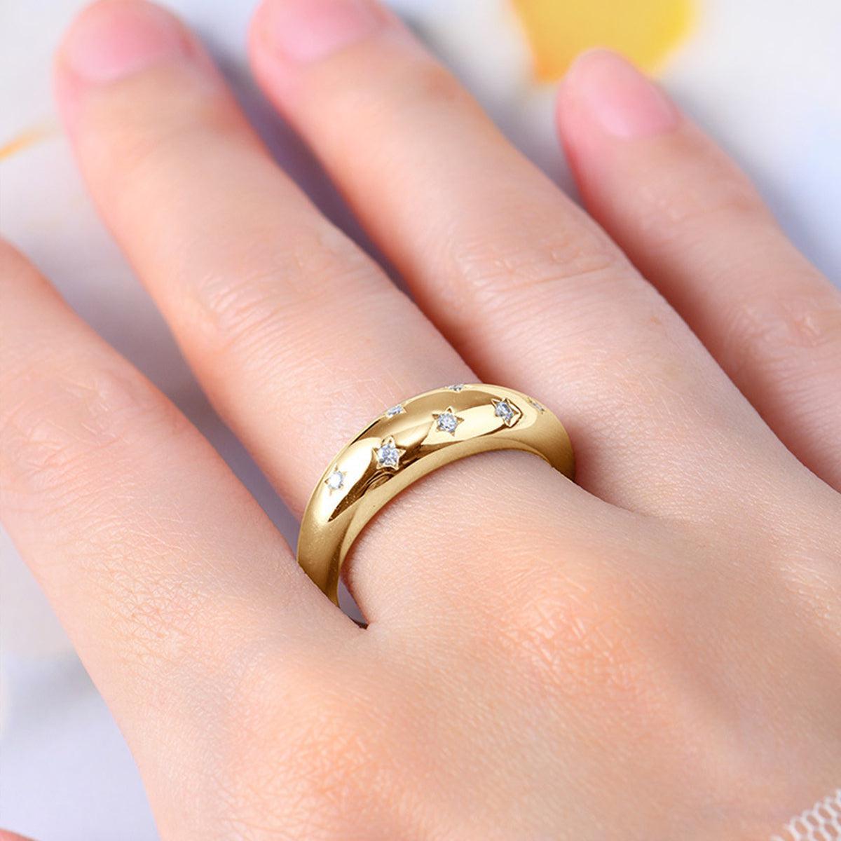a close up of a person wearing a gold ring