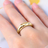 a close up of a person wearing a gold ring