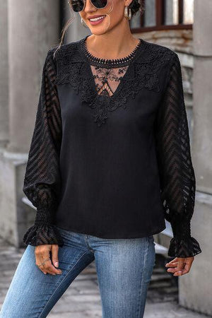 a woman wearing a black blouse and jeans