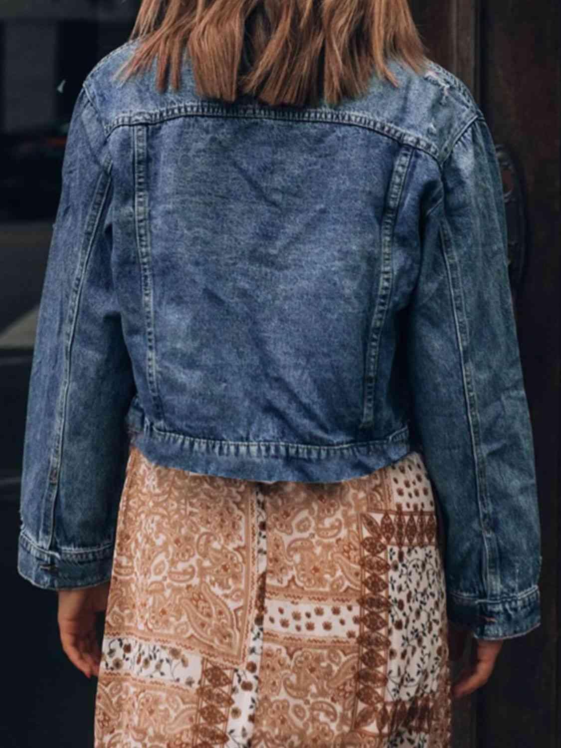 a woman wearing a denim jacket and a skirt