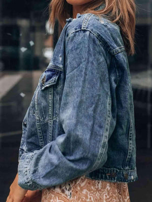 a woman wearing a denim jacket and skirt