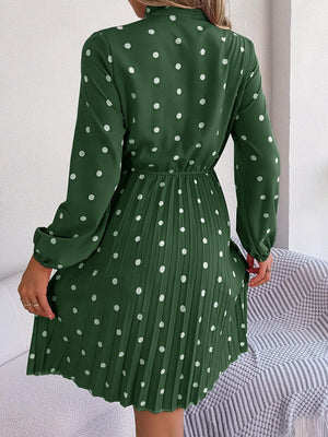 a woman in a green polka dot dress