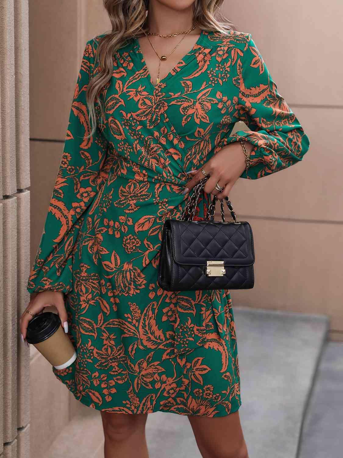 a woman in a green floral dress holding a black handbag