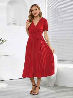 a woman in a red dress posing for a picture