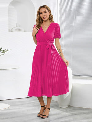 a woman in a pink dress posing for a picture