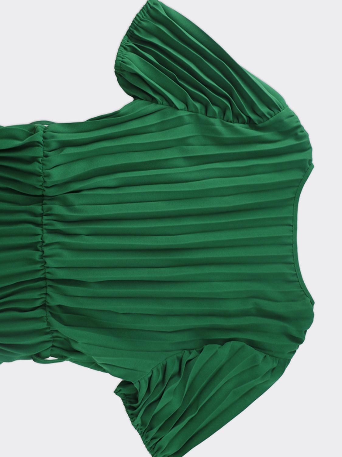 a green pleated dress is shown from above