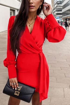 a woman in a red dress talking on a cell phone