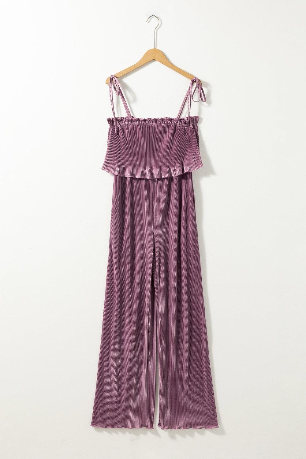 a purple jumpsuit hanging on a hanger