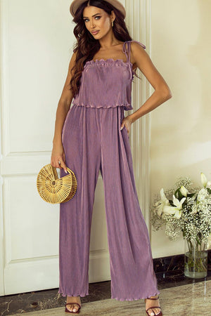 a woman in a purple jumpsuit holding a basket