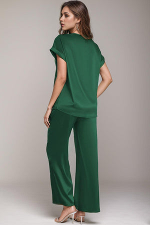 a woman in a green top and pants