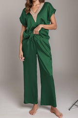 a woman in a green jumpsuit posing for a picture