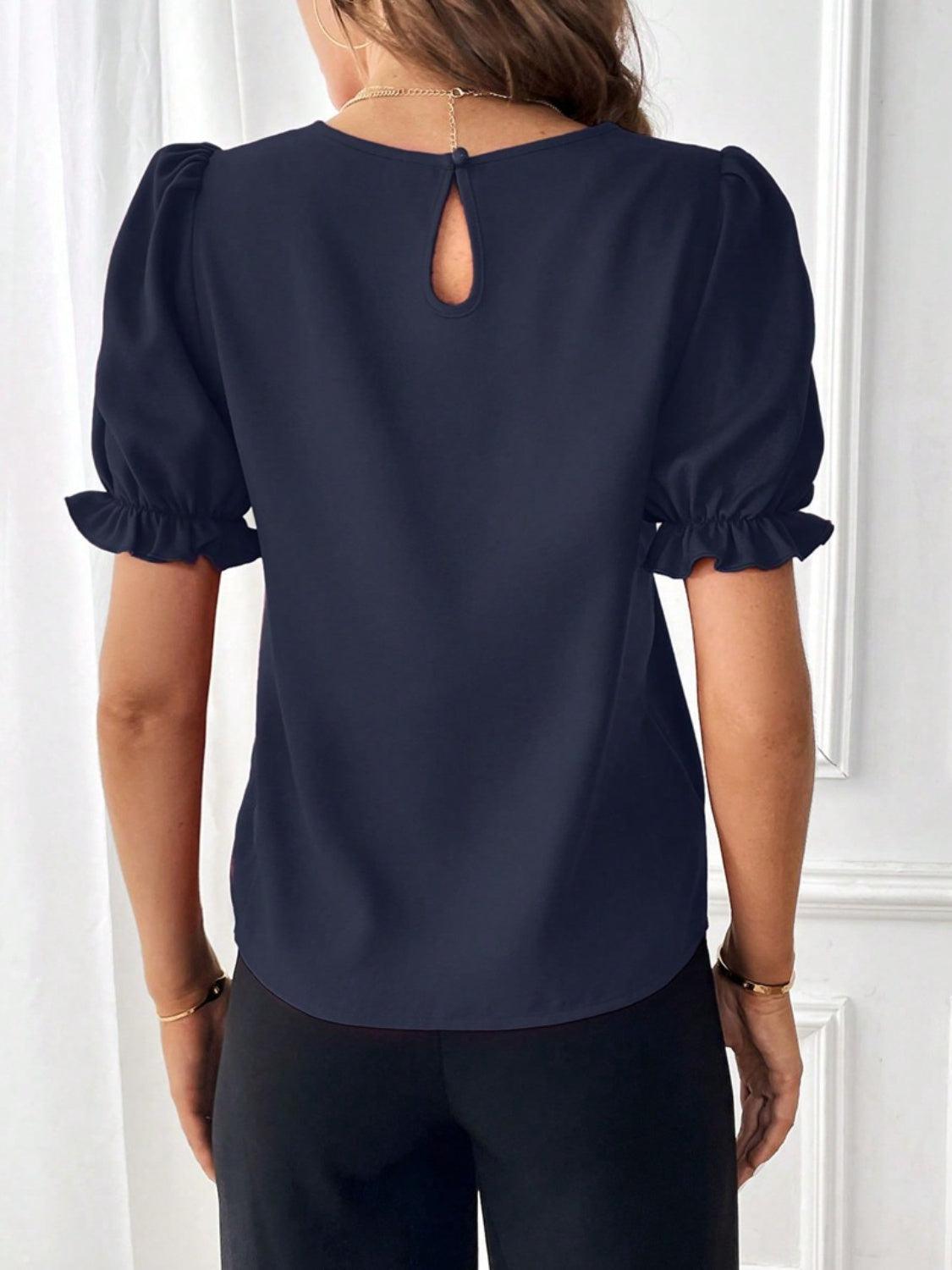 the back of a woman wearing a blue blouse