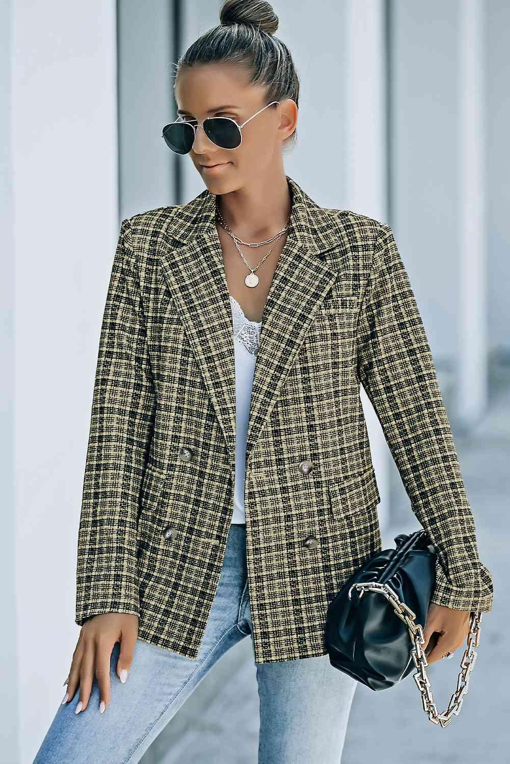 a woman in a black and white checkered blazer and jeans