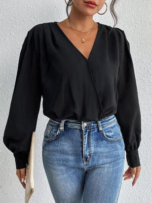 a woman wearing a black top and jeans