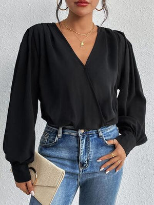 a woman wearing a black blouse and jeans