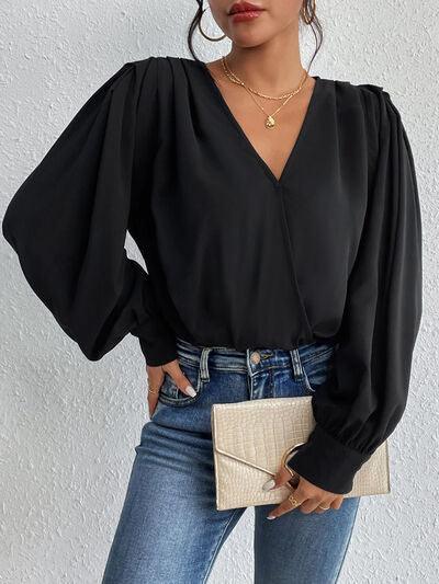 a woman wearing a black blouse and jeans