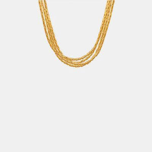 a gold necklace on a white background