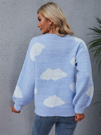 a woman wearing a blue sweater with clouds on it