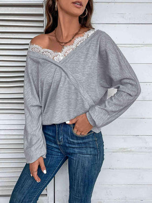 a woman wearing a grey top and jeans