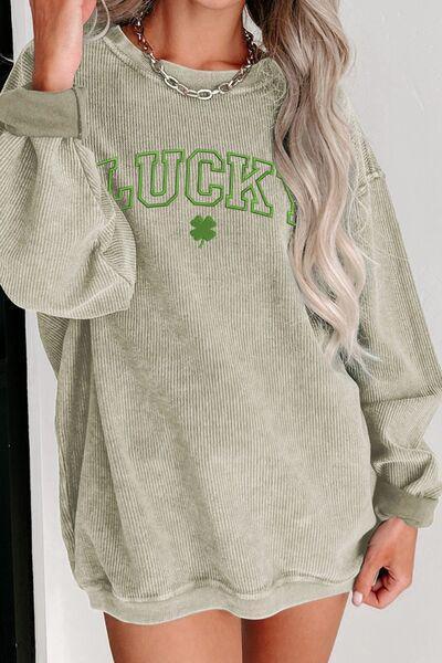 a woman wearing a green sweater with luck written on it