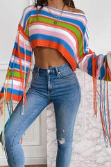 a woman in ripped jeans and a striped sweater