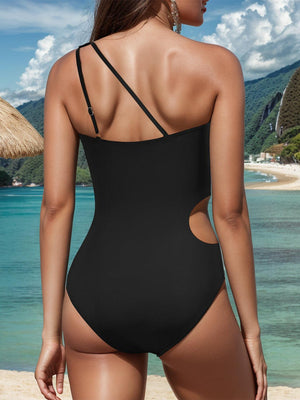 a woman in a black one piece swimsuit on the beach