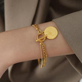 a close up of a person wearing a gold bracelet