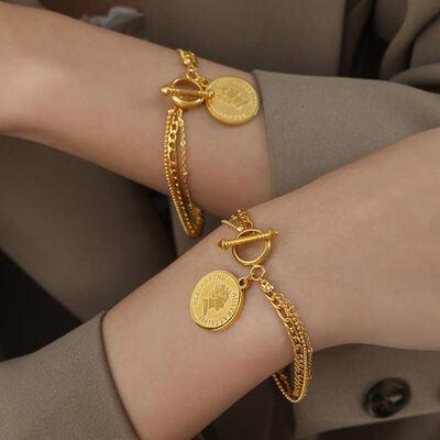 a close up of two people wearing gold bracelets