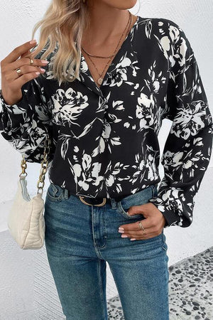 a woman wearing a black and white floral shirt