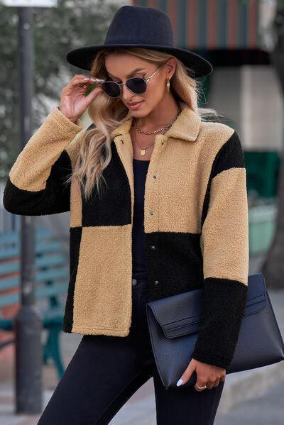 a woman wearing a black hat and a black and tan jacket