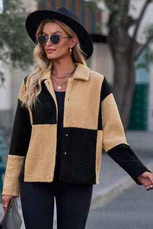 a woman walking down a street wearing a black hat