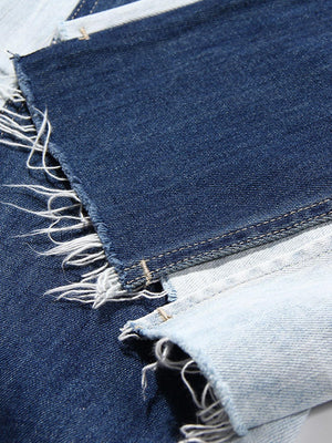a pair of blue jeans with torn edges