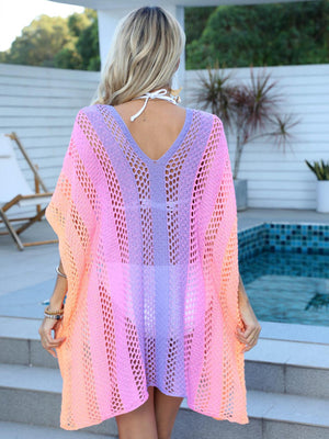 a woman wearing a pink and purple knitted cover up