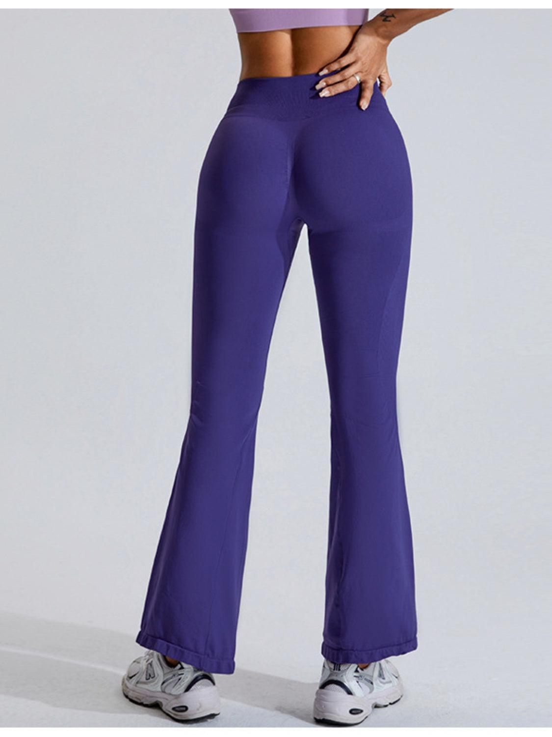 a woman in purple pants is posing for a picture