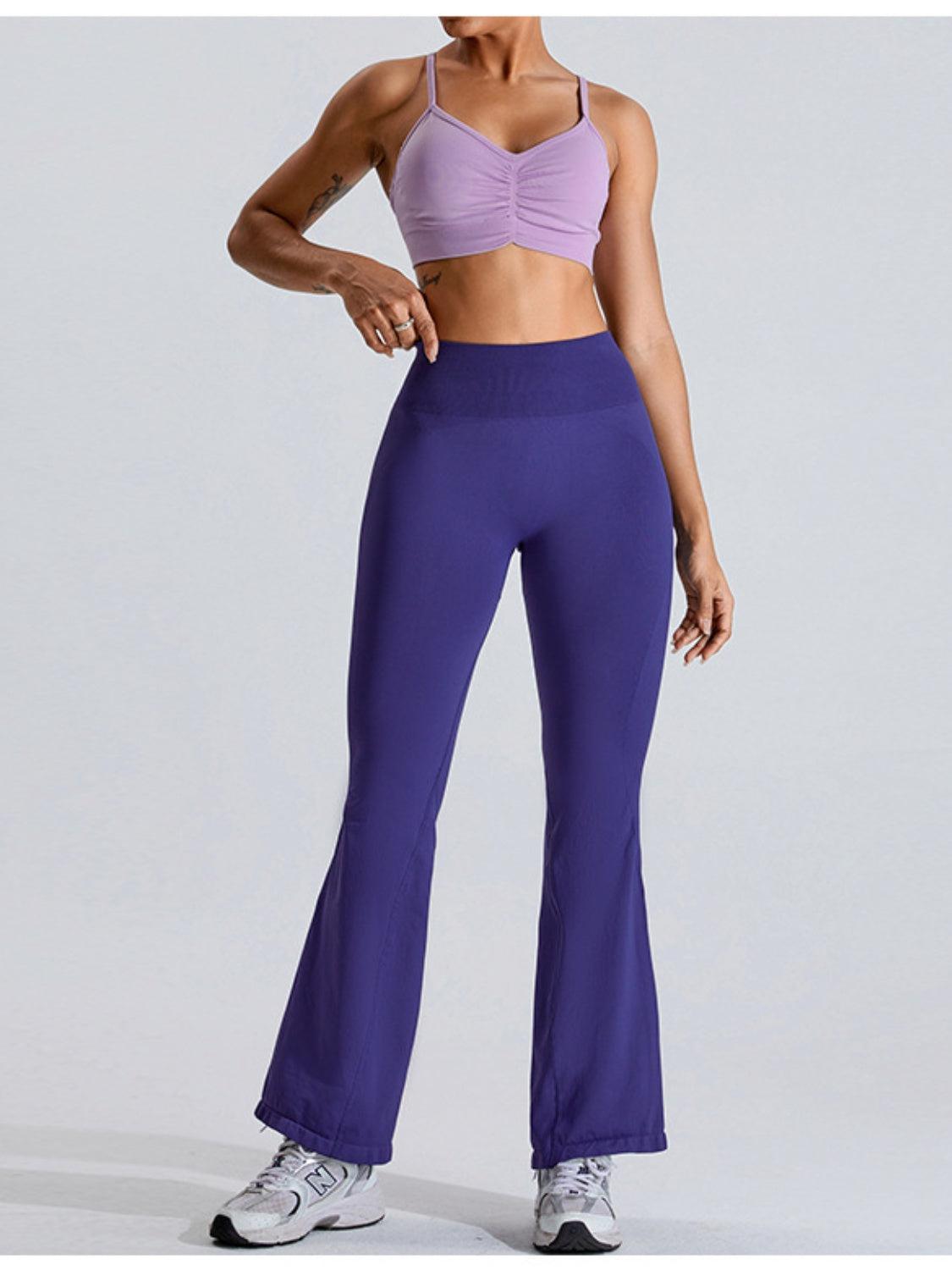a woman in a sports bra top and purple pants