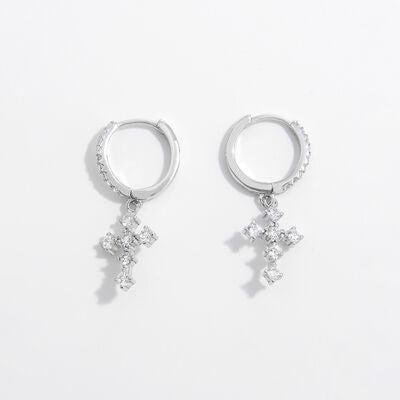 a pair of silver earrings with a cross on each ear