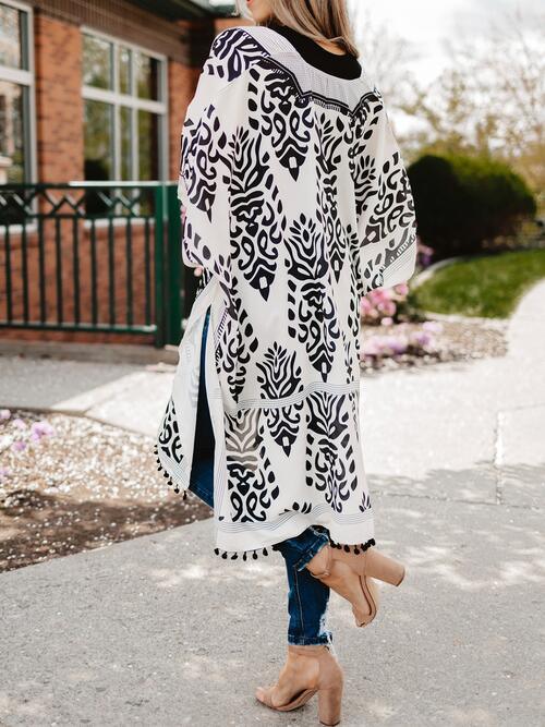 a woman wearing a black and white patterned coat