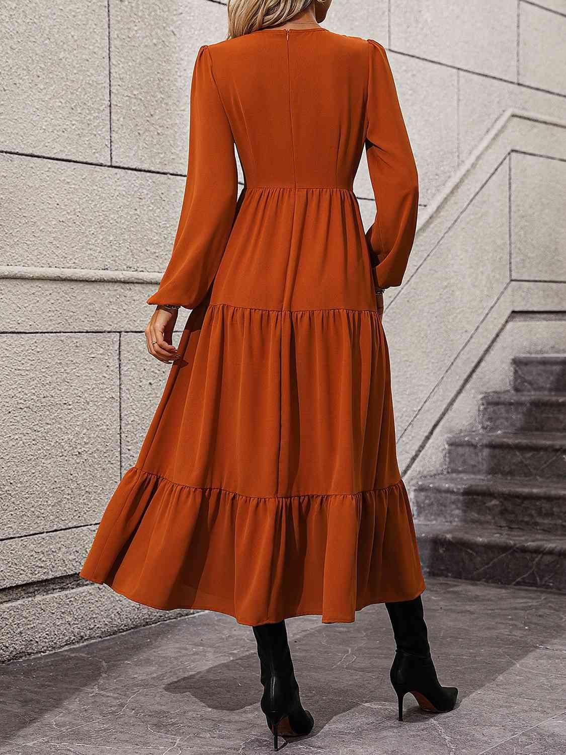 a woman wearing an orange dress and black boots