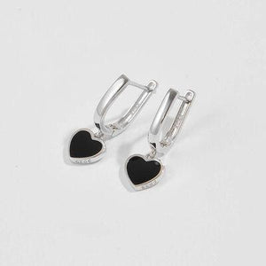 a pair of heart shaped earrings on a white background