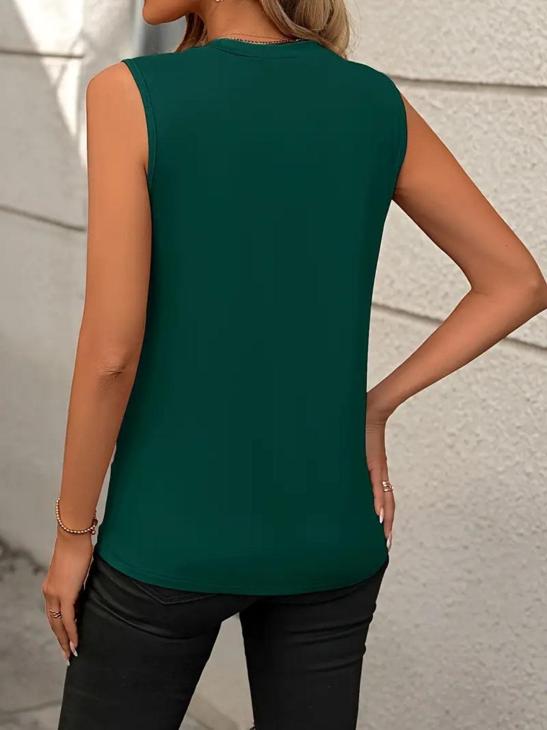 a woman wearing a green top and black pants