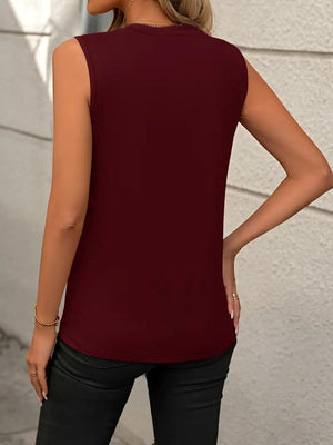 a woman wearing a maroon top and black pants