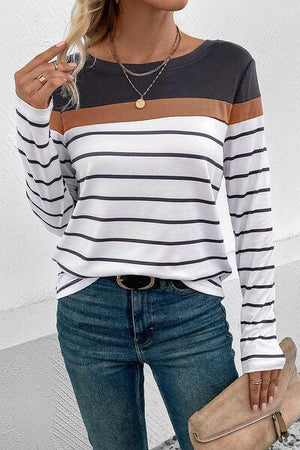 a woman wearing a striped top and jeans