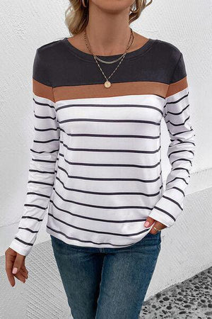 a woman wearing a white and black striped shirt