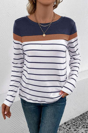 a woman wearing a striped shirt and jeans