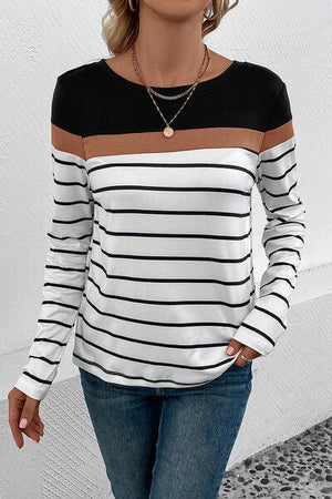 a woman wearing a black and white striped top