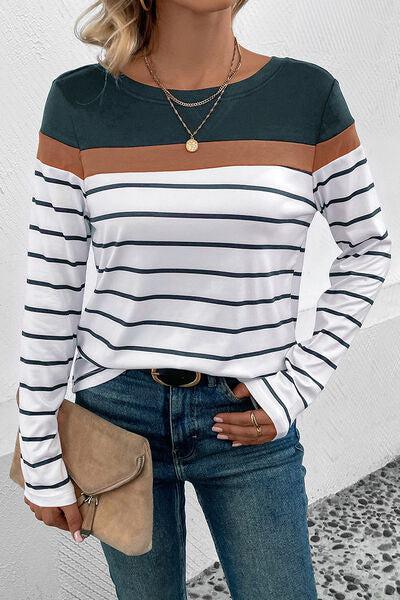 a woman wearing a striped shirt and jeans