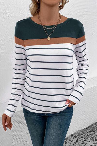 a woman wearing a striped shirt and jeans