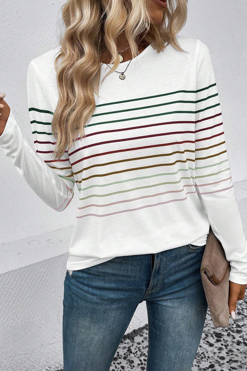 a woman wearing a white striped sweater and jeans
